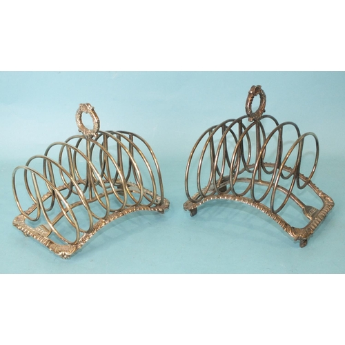 528 - A pair of early-19th century six-division toast racks of arched gadrooned form on shell and tab feet... 