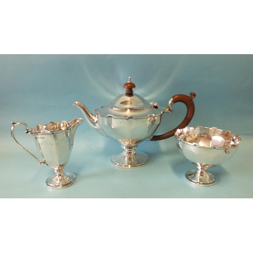 554 - A three-piece bachelor's tea service with castellated borders, raised on circular bases, Birmingham ... 