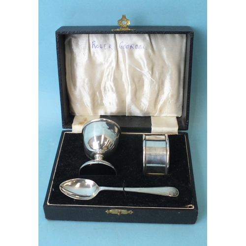 566 - A cased silver egg cup, spoon and napkin ring christening set by Alto, Birmingham 1932, ___1.77oz.... 