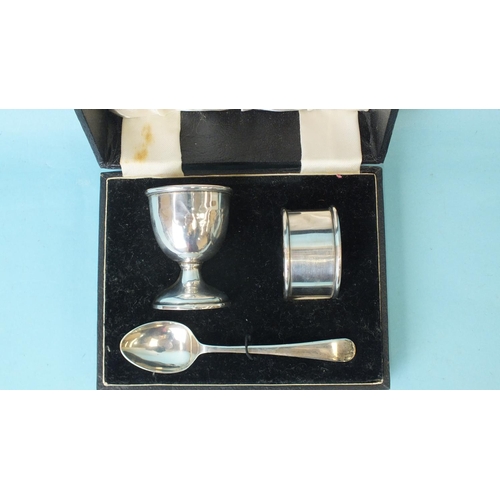 566 - A cased silver egg cup, spoon and napkin ring christening set by Alto, Birmingham 1932, ___1.77oz.... 