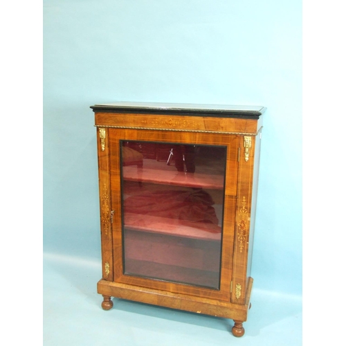 76 - A Victorian inlaid walnut gilt-metal-mounted dwarf bookcase, having a single glazed door, on short t... 