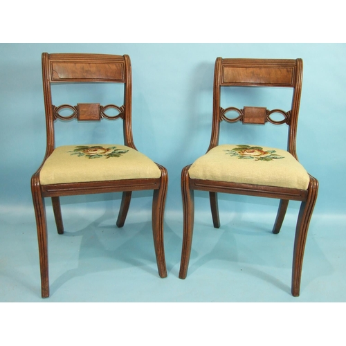 83 - A set of eight George IV mahogany dining chairs, each with pierced and reeded curved back and drop-i... 