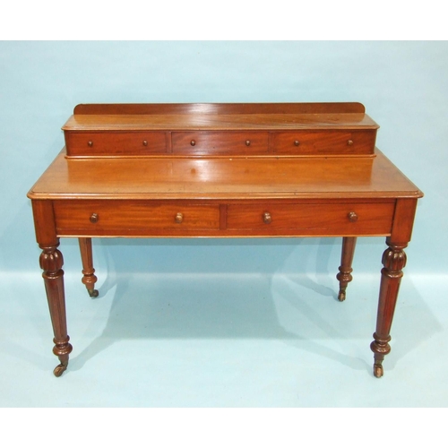 91 - A Victorian mahogany dressing table, the rectangular top surmounted by three small drawers above two... 