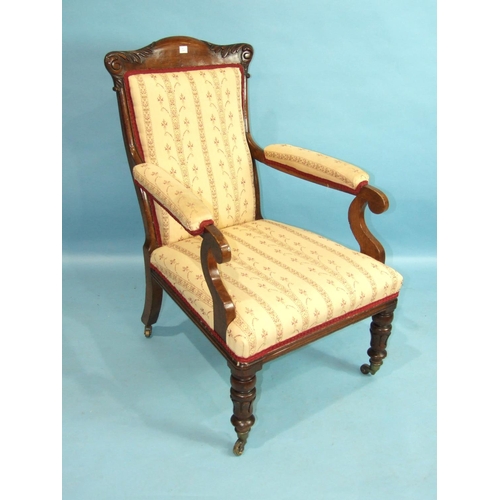 92 - A late-Victorian oak upholstered salon chair with carved frame, on short turned legs with castors.... 