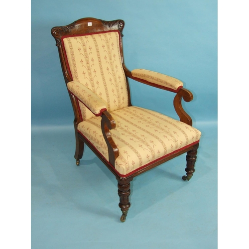 92 - A late-Victorian oak upholstered salon chair with carved frame, on short turned legs with castors.... 