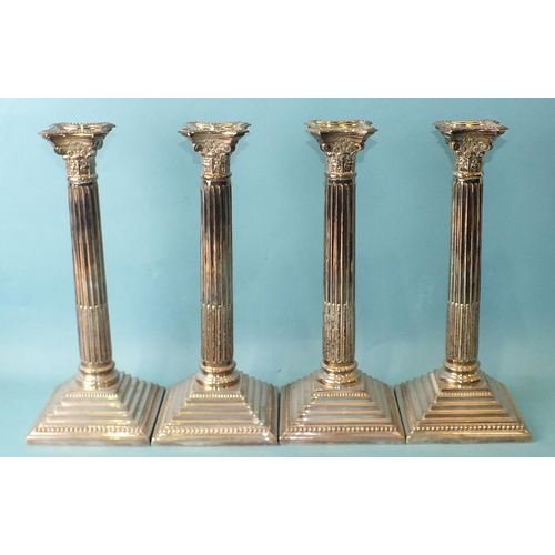 460 - A set of four 20th century silver-plated candlesticks of Corinthian column form, with beaded stepped... 