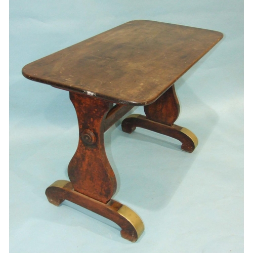 85 - A 19th century mahogany centre table, the top on shaped end supports and curved trestle feet, with b... 