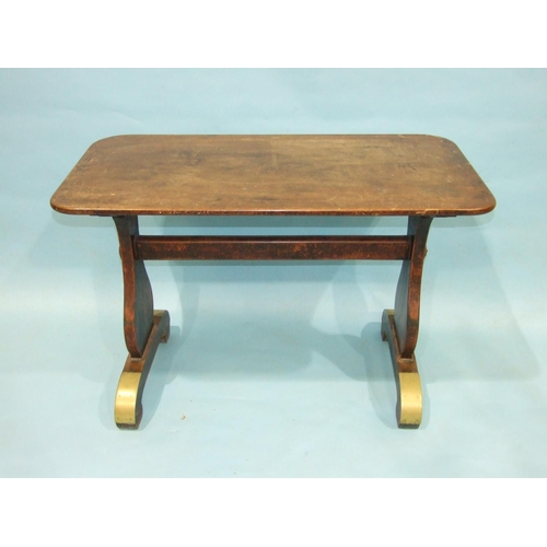 85 - A 19th century mahogany centre table, the top on shaped end supports and curved trestle feet, with b... 