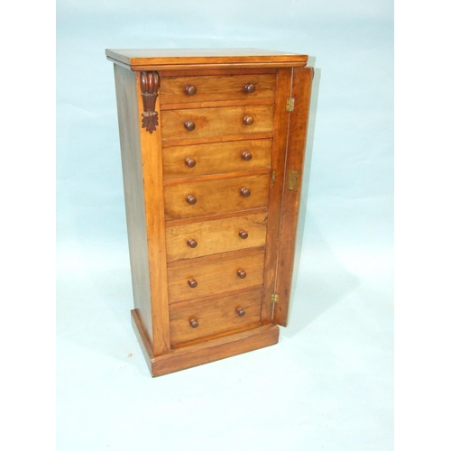 93 - A Victorian Wellington chest of seven graduated drawers, raised on plinth, 49cm wide, 102cm high.... 