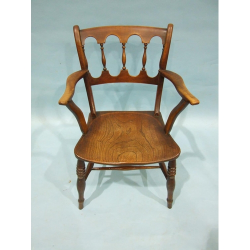 99 - A 19th century elm and fruitwood kitchen armchair with balustraded back and solid seat, on turned le... 