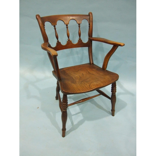 99 - A 19th century elm and fruitwood kitchen armchair with balustraded back and solid seat, on turned le... 