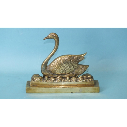 163 - A Victorian brass door stop in the form of a swan, weighted and stamped, Reg No: 728088, 21cm wide, ... 