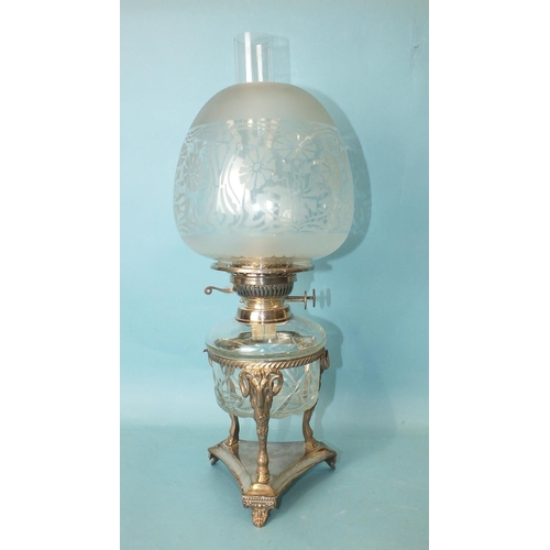 169 - A silver-plated oil lamp, the cut-glass reservoir with plated burner by E J Shaw & Co, on ram's ... 