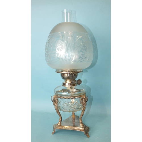 169 - A silver-plated oil lamp, the cut-glass reservoir with plated burner by E J Shaw & Co, on ram's ... 