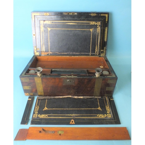 181 - A Victorian brass-bound walnut writing slope with fitted interior, including candle sconces and 'pop... 