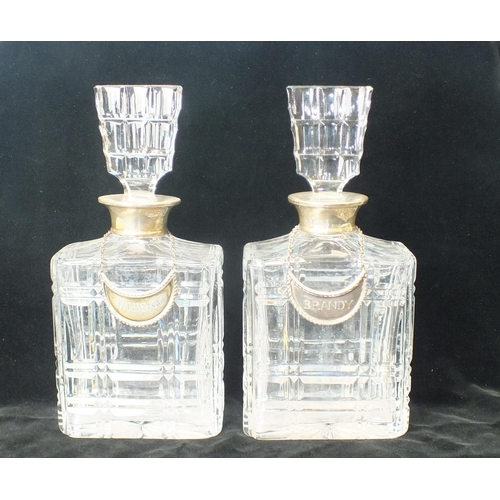 207 - A pair of square-form cut-glass decanters with silver mounts and silver wine labels, 'Brandy' and 'W... 