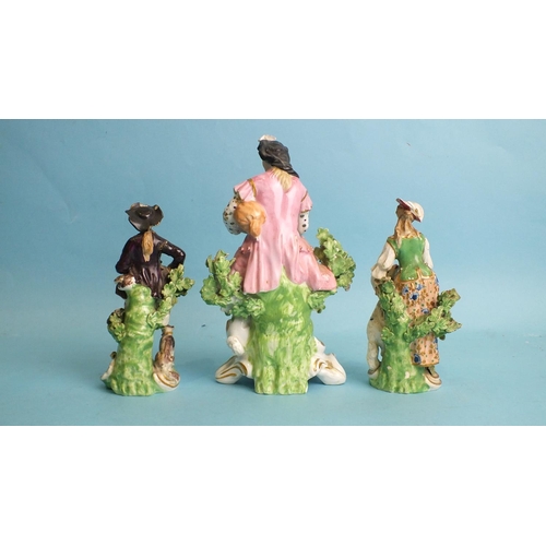 227 - An early-19th century Derby porcelain figure of a seated gentleman playing pipes and a pair of 19th ... 