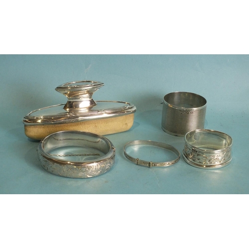 498A - Two silver napkin rings, a silver-mounted nail buffer and two bangles, (5).