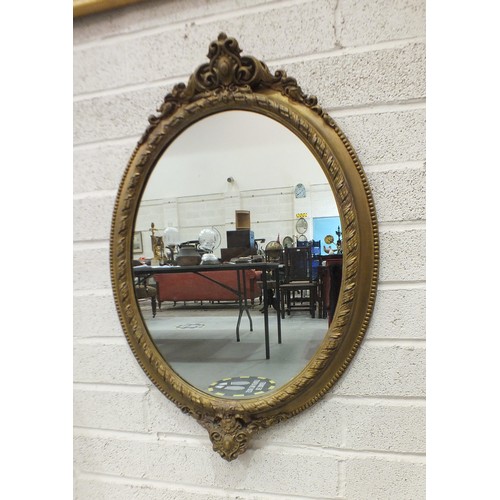 165 - A Victorian oval gilt gesso wall mirror with beaded and foliate scrolling frame, 85cm high, 58cm wid... 