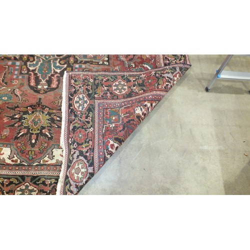 117 - A large Persian carpet, cut and joined across the centre, 340 x 298cm.