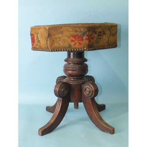 113 - An early-19th century mahogany music stool, the revolving adjustable seat, with original needlework ... 