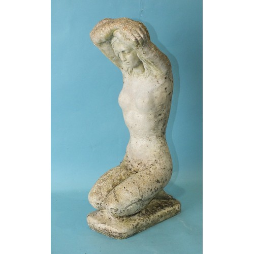 128 - A small cast concrete garden ornament in the form of a kneeling naked female figure with her arms fo... 