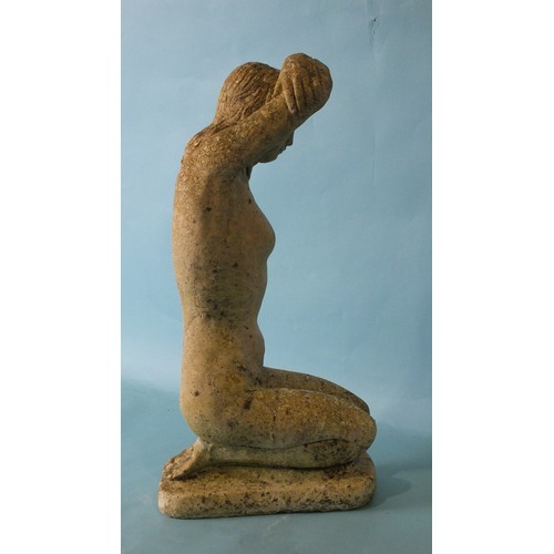 128 - A small cast concrete garden ornament in the form of a kneeling naked female figure with her arms fo... 