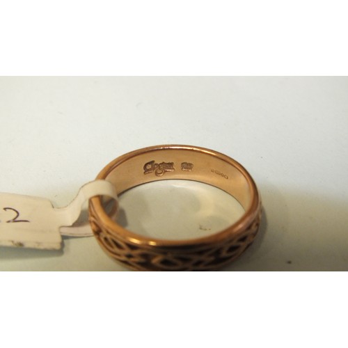 282 - A 9ct rose gold wedding band  with raised Celtic decoration, marked Clogau, 5mm wide, size O½, 4.1g.... 