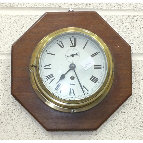 115 - A 20th century brass bulkhead barometer by John Barker, 22cm diameter and a Sestrel brass ship's clo... 