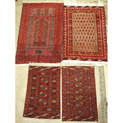 99 - A late-20th century Oriental prayer mat, 150 x 93cm and three other small Oriental rugs, (4).... 