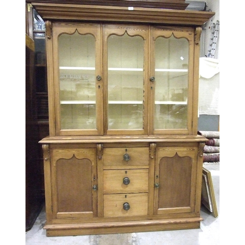 75 - A Victorian pitch pine dresser, the moulded cornice above three glazed doors, the lower part with th... 