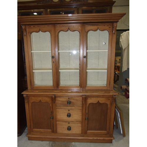 75 - A Victorian pitch pine dresser, the moulded cornice above three glazed doors, the lower part with th... 