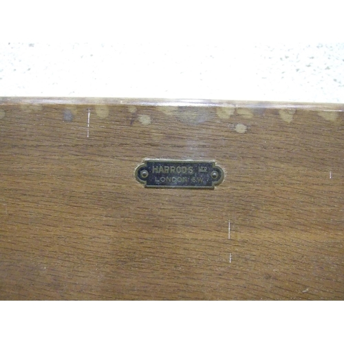 89 - An oak and cast-iron adjustable bed table labelled Harrods Ltd, London SW, an oak dressing glass, th... 