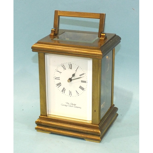 A modern brass carriage clock with bell-striking movement, the case with  reeded pillars, enclosing a
