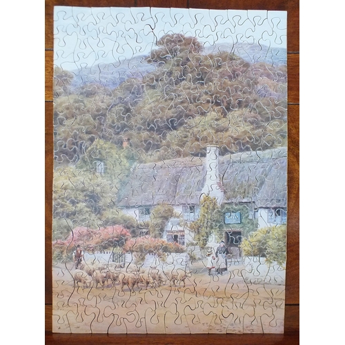440 - Two wooden jigsaws, (one complete), an album of cigarette cards, two leather stationery folders and ... 