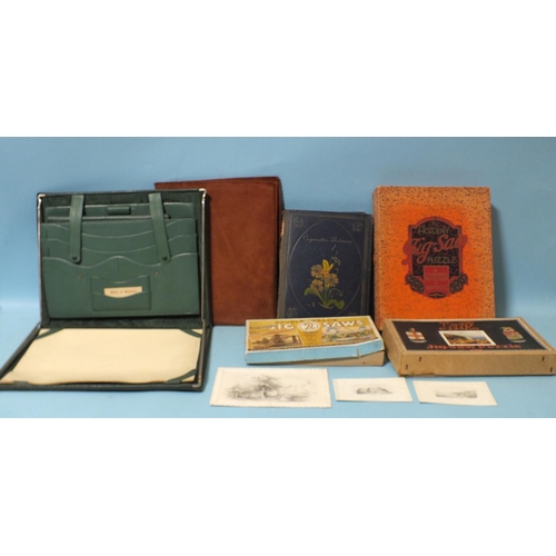 440 - Two wooden jigsaws, (one complete), an album of cigarette cards, two leather stationery folders and ... 