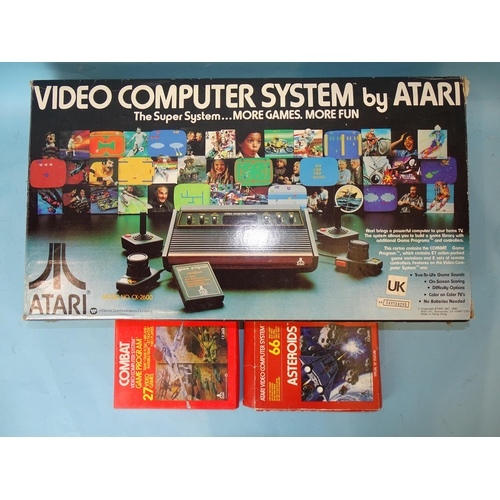444 - An Atari video computer system, model no. CX-2600, boxed with instructions and two games, 27 'Combat... 