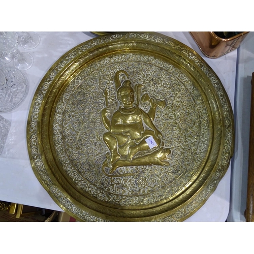 102 - A brass circular Benares tray embossed with a deity, 51cm diameter, (a/f), a working horse's leather... 