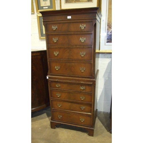 28 - A reproduction mahogany chest of nine drawers, with brushing slide, 64 x 157cm and a mahogany oval-t... 