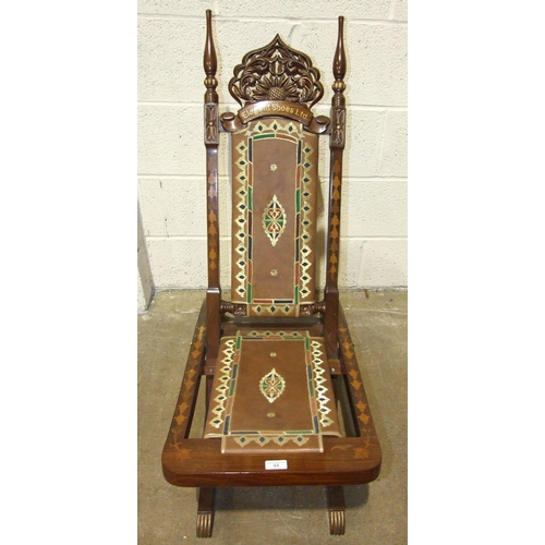 33 - An inlaid hardwood folding chair with leather panel seat and back, the back inlaid with 'Elegant Sho... 