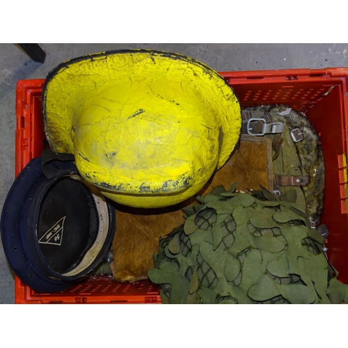 70 - A military tin helmet with camouflage, a Devon Fire Brigade yellow helmet and miscellaneous items.... 