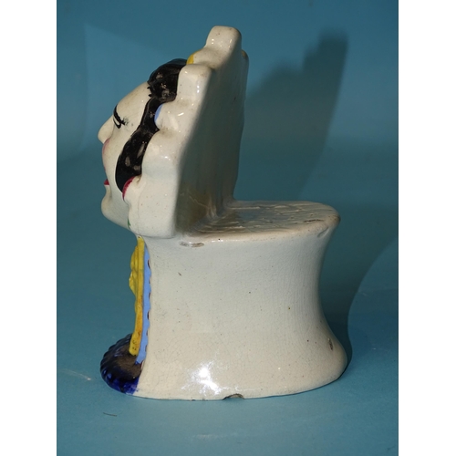 189 - A mid-19th century pearlware mask-head furniture rest, 13cm high, 9cm wide, (manufacturing fault).... 