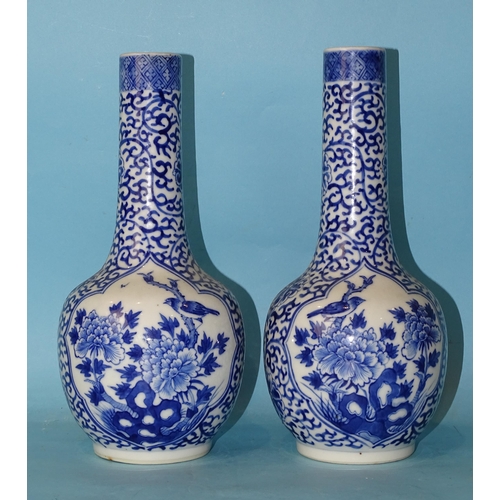 199 - A pair of 19th century Chinese porcelain bottle vases decorated with panels of birds in branches, on... 