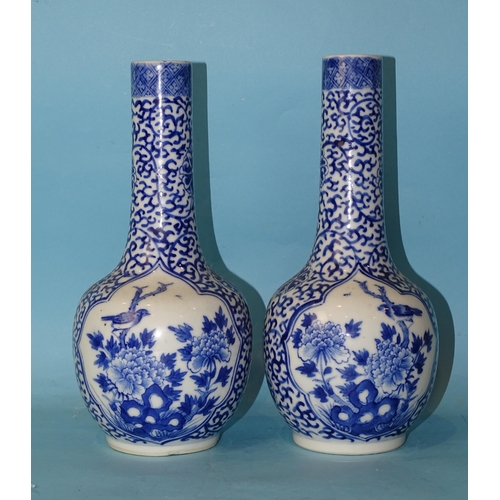 199 - A pair of 19th century Chinese porcelain bottle vases decorated with panels of birds in branches, on... 