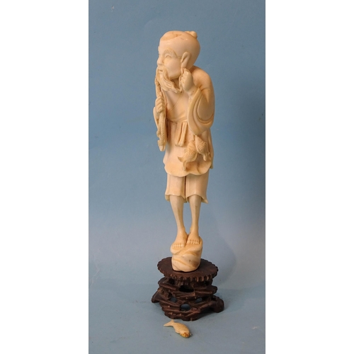 210 - A Japanese ivory figure of an old man fishing, Meiji, 18cm.