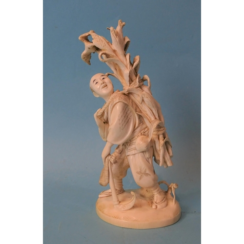 211 - A Japanese ivory figure of a man collecting maize, Meiji, 14cm high, (red seal mark to base).... 