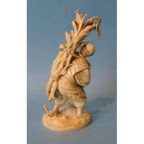 211 - A Japanese ivory figure of a man collecting maize, Meiji, 14cm high, (red seal mark to base).... 