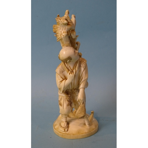 211 - A Japanese ivory figure of a man collecting maize, Meiji, 14cm high, (red seal mark to base).... 