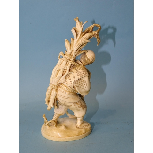 211 - A Japanese ivory figure of a man collecting maize, Meiji, 14cm high, (red seal mark to base).... 