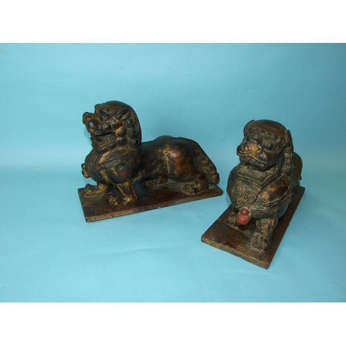 215 - A pair of Oriental carved wood and gilt lacquered temple dogs, 24cm high, 33cm wide.... 